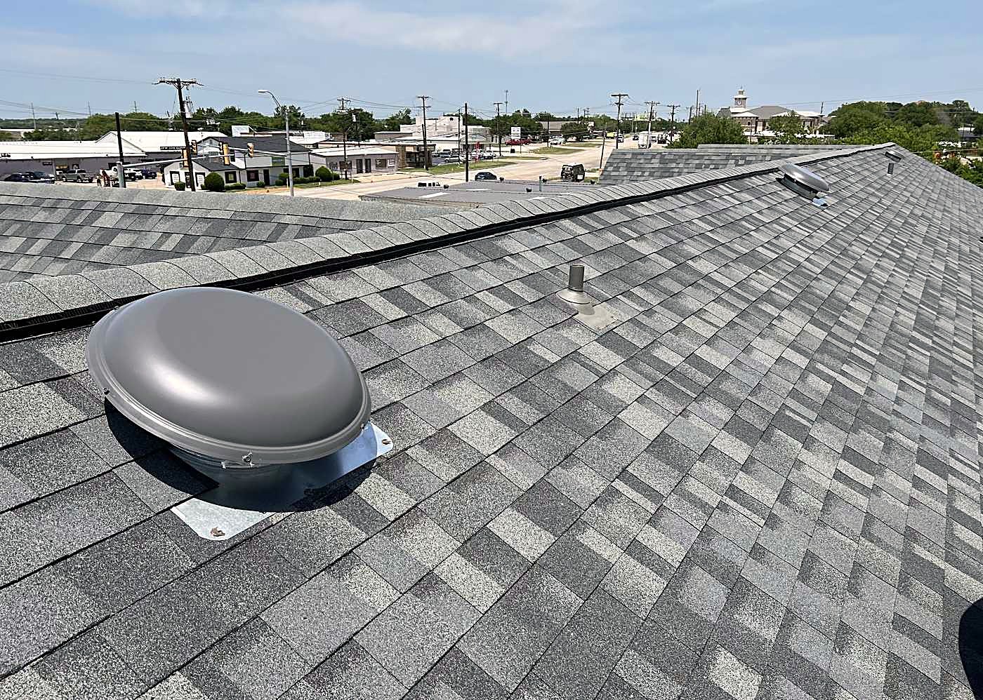 A close look at a finished shingle field and a turbine vent
