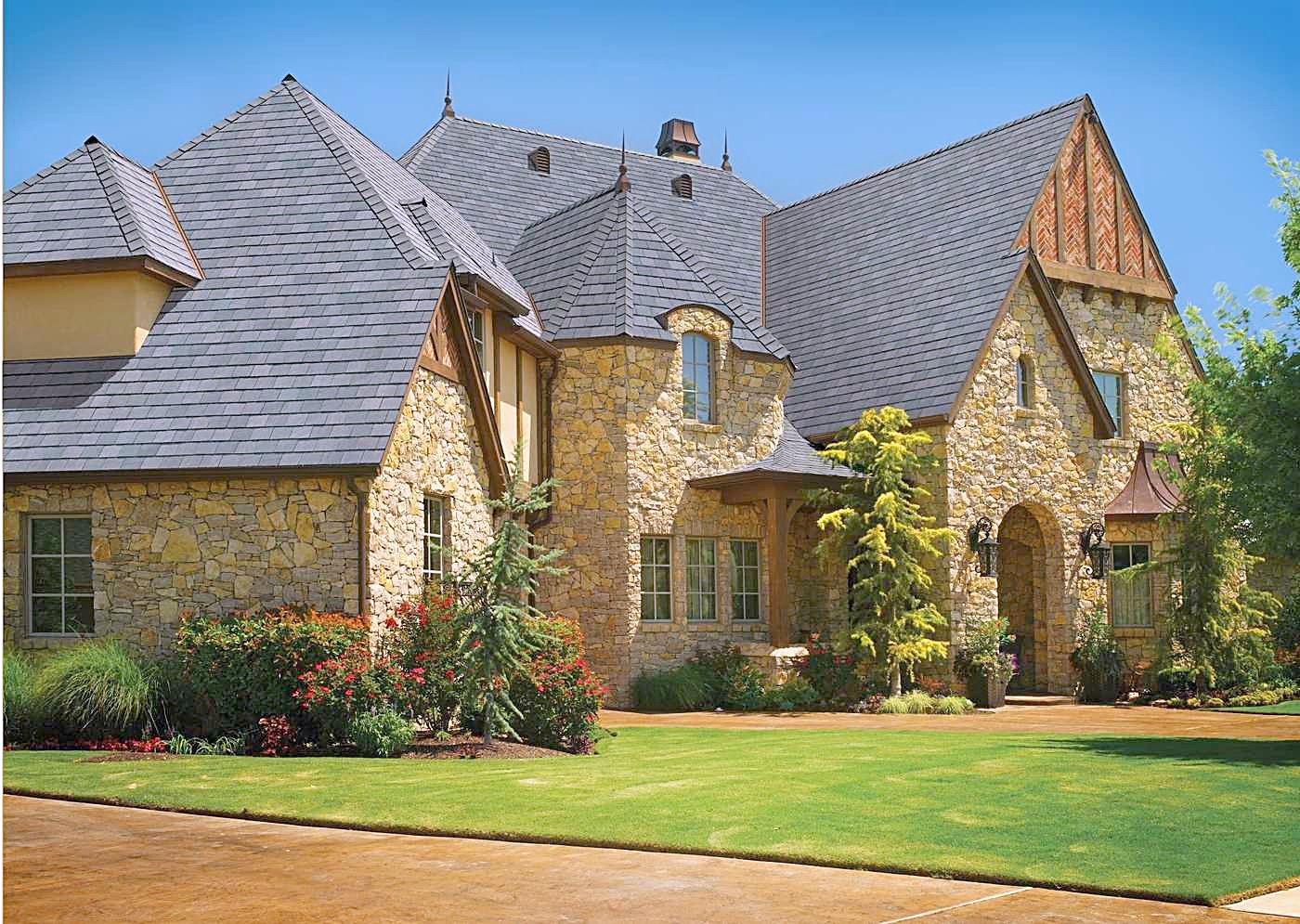 A large stone home with its finished roof